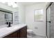 Bathroom featuring a framed mirror, solid surface vanity, and walk in shower with sliding glass door at 18 Palmira Rd, Debary, FL 32713