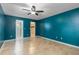 Large bedroom with wood-look tile flooring, a ceiling fan, and ensuite bathroom at 18 Palmira Rd, Debary, FL 32713