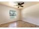 Bedroom with wood-look tile floors, ceiling fan, and a window for natural light at 18 Palmira Rd, Debary, FL 32713