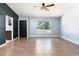 Bright living room featuring wood-look tile flooring, neutral walls, and a ceiling fan at 18 Palmira Rd, Debary, FL 32713