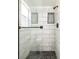 Updated shower with white subway tile surround, built-in niches, and a pebble tile floor at 18 Palmira Rd, Debary, FL 32713