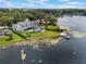 Expansive lakeside property with a modern home, pool, dock, and lush greenery at 1891 Lake Spier Dr, Winter Park, FL 32789