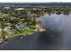 Aerial view showing property location, a modern home, lake frontage and lush landscaping at 1891 Lake Spier Dr, Winter Park, FL 32789