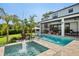 Luxurious backyard oasis with pool, spa, water features, and outdoor living space for entertaining at 1891 Lake Spier Dr, Winter Park, FL 32789