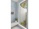 Modern bathroom featuring stylish tile work, a floating bench and a view of an outdoor garden at 1891 Lake Spier Dr, Winter Park, FL 32789
