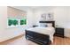 Bedroom featuring a dark wood bed frame, view of the lake, bedside tables, and neutral decor at 1891 Lake Spier Dr, Winter Park, FL 32789