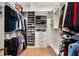Spacious walk-in closet with custom shelving, drawers and hanging rods for optimal organization at 1891 Lake Spier Dr, Winter Park, FL 32789