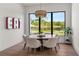 Cozy dining area with views of the lake, featuring a statement chandelier and stylish decor at 1891 Lake Spier Dr, Winter Park, FL 32789