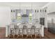 Well-appointed kitchen island with seating, pendant lights, and stylish backsplash at 1891 Lake Spier Dr, Winter Park, FL 32789