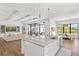 Open-concept kitchen featuring marble countertops, pendant lighting, and seamless flow into the living space at 1891 Lake Spier Dr, Winter Park, FL 32789