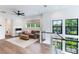 Upstairs living room with cozy seating, neutral decor, and scenic views from large windows at 1891 Lake Spier Dr, Winter Park, FL 32789