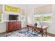 Bright office space featuring a rustic wooden desk, a wooden credenza, and a view of the lake at 1891 Lake Spier Dr, Winter Park, FL 32789