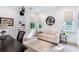 Bright home office with built-in shelving, comfortable seating, and ample natural light at 1891 Lake Spier Dr, Winter Park, FL 32789