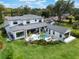 Aerial view of a modern home featuring a luxurious pool, manicured lawn, and inviting outdoor space at 1891 Lake Spier Dr, Winter Park, FL 32789