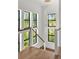 Modern staircase with wood treads, cable railing, and an abundance of natural light from large windows at 1891 Lake Spier Dr, Winter Park, FL 32789