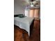 Bedroom featuring a large bed, light-colored linens, a ceiling fan, and neutral curtains at 2157 Island Walk Dr, Orlando, FL 32824