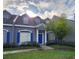 Charming townhouse with blue shutters, a blue front door, and a well-manicured lawn at 2157 Island Walk Dr, Orlando, FL 32824