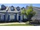 Charming two-story townhome with blue shutters, a well-maintained lawn, and mature tree at 2157 Island Walk Dr, Orlando, FL 32824