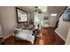 Bright living room features wood-look tile floors, neutral sofa, large window and stairway at 2157 Island Walk Dr, Orlando, FL 32824