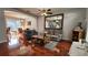 Comfortable living room with dark wood-look tile, neutral-toned sofas, and dining room beyond at 2157 Island Walk Dr, Orlando, FL 32824