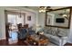 Inviting living room boasts stylish couches, coffee table, and mirror, seamlessly flowing into the adjacent dining area at 2157 Island Walk Dr, Orlando, FL 32824