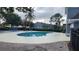 Community pool surrounded by lush landscaping and lounge chairs for relaxing at 2157 Island Walk Dr, Orlando, FL 32824