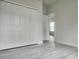 Spacious bedroom with large closet, light gray walls and wood-look flooring at 2333 Sw 147Th Pl Rd, Ocala, FL 34473