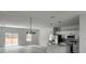 Bright, open-concept living room featuring sleek floors, recessed lighting, and an adjacent kitchen with modern finishes at 2333 Sw 147Th Pl Rd, Ocala, FL 34473