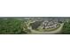 Panoramic aerial view of the neighborhood surrounded by lush greenery and a winding lake at 2501 Grassy Point Dr # 103, Lake Mary, FL 32746