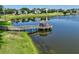 Picturesque lake features a charming gazebo-covered dock, offering serene water access at 2501 Grassy Point Dr # 103, Lake Mary, FL 32746