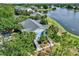 Aerial view of lakeside condos, surrounded by lush trees and serene lake views at 2501 Grassy Point Dr # 103, Lake Mary, FL 32746