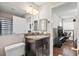 Bathroom showing granite countertop vanity and open door to room with desk and game chair at 2501 Grassy Point Dr # 103, Lake Mary, FL 32746