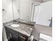 Bathroom features granite counters, a large mirror, and a white sink at 2501 Grassy Point Dr # 103, Lake Mary, FL 32746