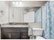 Bathroom featuring a large mirror, granite counters, and a patterned shower curtain at 2501 Grassy Point Dr # 103, Lake Mary, FL 32746