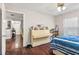Bedroom showcasing hardwood floors and an upright piano at 2501 Grassy Point Dr # 103, Lake Mary, FL 32746