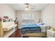 Bedroom with a piano and a bed with striped bedding, hardwood floors, and white walls at 2501 Grassy Point Dr # 103, Lake Mary, FL 32746