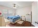 Cozy bedroom featuring hardwood floors, ceiling fan, and ample natural light at 2501 Grassy Point Dr # 103, Lake Mary, FL 32746
