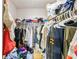 Walk-in closet with hanging clothes and wire shelving at 2501 Grassy Point Dr # 103, Lake Mary, FL 32746