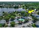 An aerial view of community amenities including a pool, basketball court, and a picturesque pond at 2501 Grassy Point Dr # 103, Lake Mary, FL 32746