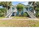 Charming condo building featuring exterior stairs, tasteful landscaping and mature palm trees in a well maintained community at 2501 Grassy Point Dr # 103, Lake Mary, FL 32746