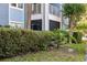 Exterior view of a condo building with a screened-in ground floor porch at 2501 Grassy Point Dr # 103, Lake Mary, FL 32746