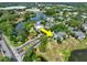 A high-angle view of residential buildings, landscaping and a pond at 2501 Grassy Point Dr # 103, Lake Mary, FL 32746
