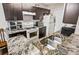 The kitchen features granite counters, stainless steel appliances and dark wood cabinets at 2501 Grassy Point Dr # 103, Lake Mary, FL 32746