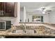 Updated kitchen includes a dual basin sink, granite counters and bar-style pass-through at 2501 Grassy Point Dr # 103, Lake Mary, FL 32746