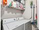 Bright laundry room with washer, dryer, wire shelving, and cleaning supplies at 2501 Grassy Point Dr # 103, Lake Mary, FL 32746