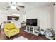 Open-concept living room with hardwood floors, yellow chair, and kitchen view at 2501 Grassy Point Dr # 103, Lake Mary, FL 32746