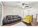 Inviting living room features a comfortable dark brown leather sofa and bright yellow chair at 2501 Grassy Point Dr # 103, Lake Mary, FL 32746