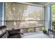 Screened-in patio with view of lush trees and yard, with comfortable seating area at 2501 Grassy Point Dr # 103, Lake Mary, FL 32746