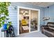 Relaxing patio with view into a modern living room with yellow armchair, wood floors, and a ceiling fan at 2501 Grassy Point Dr # 103, Lake Mary, FL 32746