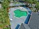 A high-angle view of the community pool, and basketball court, surrounded by palm trees and patio furniture at 2501 Grassy Point Dr # 103, Lake Mary, FL 32746